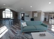 Thumbnail 13 of 32 - a living room with a couch and a table and chairs