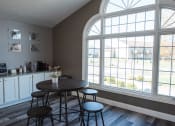 Thumbnail 14 of 32 - an empty room with tables and chairs and large windows