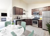 Thumbnail 1 of 32 - a kitchen with stainless steel appliances and a dining table