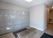 Thumbnail 20 of 32 - a row of lockers in a room with a bench