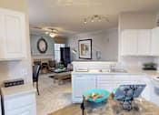 Thumbnail 3 of 32 - kitchen with white cabinets and living room