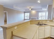 Thumbnail 15 of 32 - a kitchen with a sink and a ceiling fan