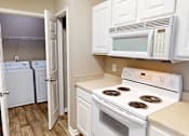 Thumbnail 12 of 32 - apartment kitchen with appliances including microwave