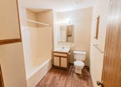 Thumbnail 8 of 23 - A small bathroom with a toilet, sink, and shower.