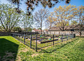 Thumbnail 15 of 23 - A black fence surrounds a green lawn.