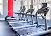 Thumbnail 10 of 11 - Apartment fitness center with treadmills