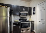 Thumbnail 3 of 11 - Apartment kitchen with stainless steel appliances
