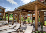 Thumbnail 11 of 11 - A wooden pergola with lounge chairs at Bluegrass Villas