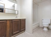 Thumbnail 16 of 29 - Bathroom area with large mirror and undersink storage