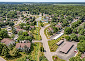 Thumbnail 22 of 22 - A bird's eye view of a residential area with houses, a swimming pool, and a parking lot.