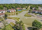 Thumbnail 20 of 22 - A flooded residential area with houses and a swimming pool.
