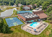 Thumbnail 19 of 22 - A large building with a pool and a basketball court.