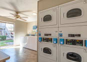 Thumbnail 8 of 24 - On-Site Laundry Facility at Camelot Apartments