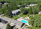 Thumbnail 41 of 41 - A bird's eye view of a residential area with a swimming pool.