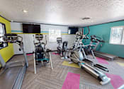 Thumbnail 20 of 41 - A gym with treadmills, elliptical machines, and exercise bikes.