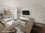 Thumbnail 1 of 28 - A modern living room with a flat screen TV mounted on the wall.