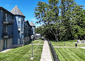 Thumbnail 35 of 41 - A row of blue buildings with a walkway in between.