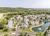 Thumbnail 14 of 16 - A bird's eye view of a residential neighborhood with houses and a lake.