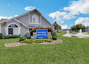 Thumbnail 12 of 16 - A blue sign with the word "crystalbay" on it is in front of a house.