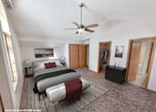 Thumbnail 5 of 16 - A bedroom with a bed, a dresser, and a ceiling fan.
