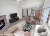 Thumbnail 6 of 16 - A living room with a fireplace and a television.