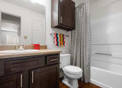 Thumbnail 10 of 30 - a bathroom with a white toilet and a shower