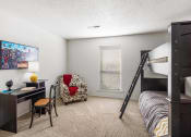 Thumbnail 6 of 30 - a bedroom with a bunk bed and a desk