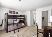 Thumbnail 7 of 30 - a bedroom with a bunk bed and a desk