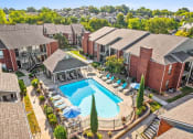 Thumbnail 24 of 30 - an aerial view of a swimming pool surrounded by apartments