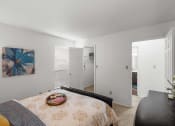 Thumbnail 27 of 30 - a bedroom with a bed and a door to a bathroom