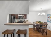 Thumbnail 3 of 30 - a kitchen with a bar and a dining table