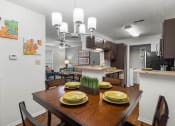 Thumbnail 29 of 30 - a kitchen and dining room with a table with plates on it