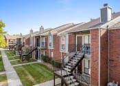Thumbnail 23 of 30 - a row of brick apartment buildings with stairs