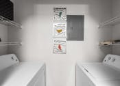 Thumbnail 12 of 30 - a white laundry room with two washes and a dryer