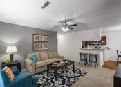 Thumbnail 1 of 30 - a living room with a couch and a ceiling fan