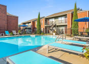 Thumbnail 19 of 30 - a large swimming pool with some chairs around it