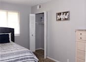 Thumbnail 15 of 17 - A bedroom with a bed, dresser, and a closet with a sign that says