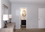 Thumbnail 9 of 17 - A room with a white door and a mirror on the wall.