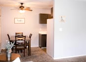 Thumbnail 2 of 17 - A dining room with a table set for two and a framed sign that says