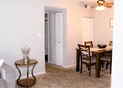 Thumbnail 3 of 17 - A dining room with a table and chairs.