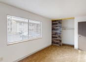 Thumbnail 3 of 34 - a living room with a large window and a door to a closet