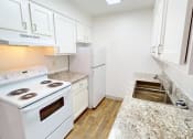 Thumbnail 34 of 34 - a kitchen with white appliances and white cabinets