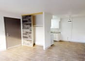 Thumbnail 5 of 34 - an empty living room and kitchen with a wood floor