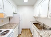 Thumbnail 8 of 34 - a kitchen with marble counter tops and white cabinets