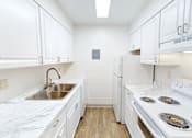 Thumbnail 1 of 28 - A kitchen with white cabinets and a white stove top oven.