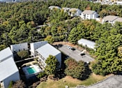 Thumbnail 26 of 27 - arial view of a house surrounded by trees and buildings
