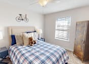 Thumbnail 10 of 27 - a bedroom with a bed and a bike on the wall