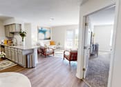 Thumbnail 5 of 27 - a living room with a kitchen and a dining room