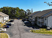 Thumbnail 22 of 27 - a view of a street with houses and cars in a parking lot