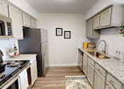 Thumbnail 8 of 27 - a kitchen with granite counter tops and stainless steel appliances